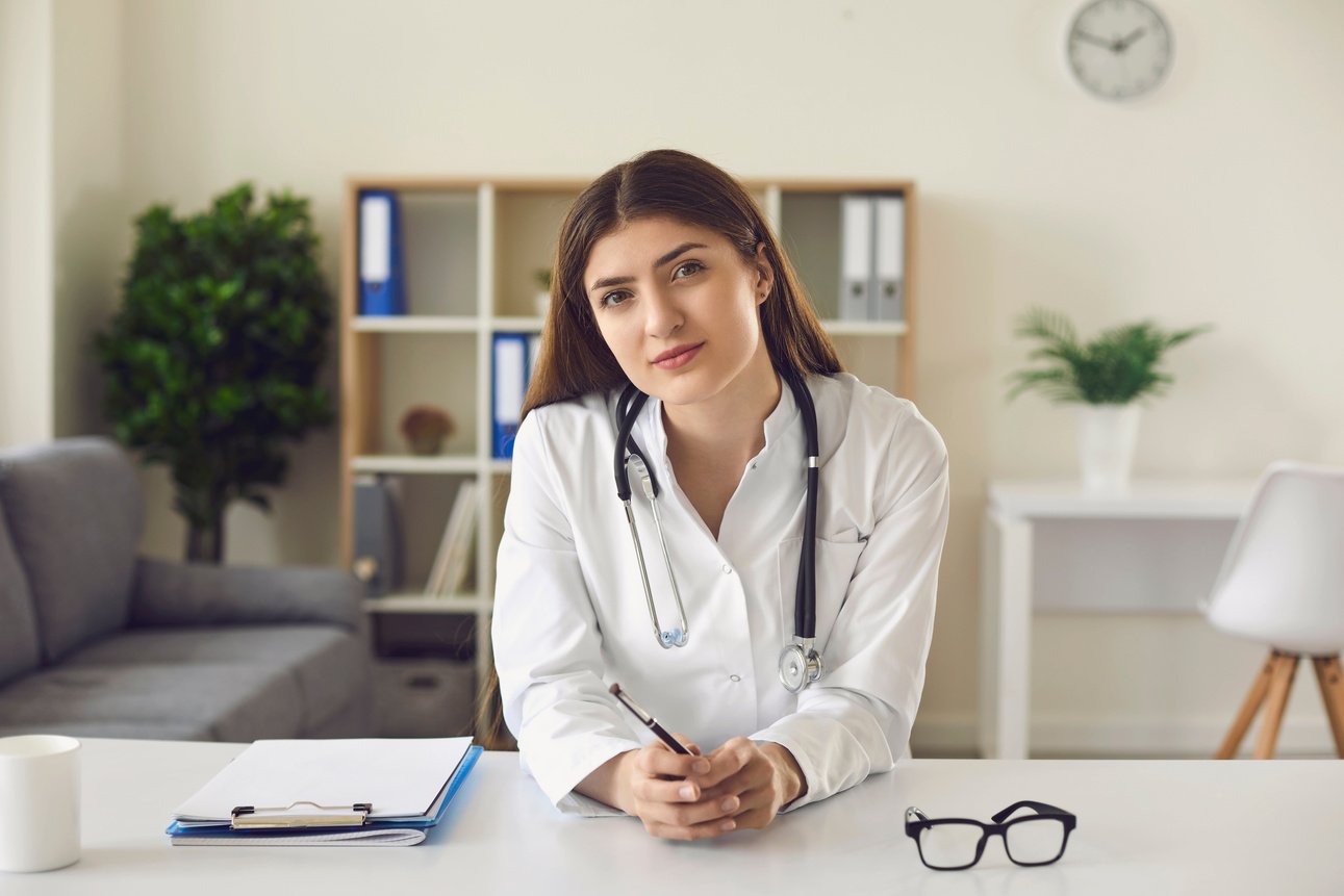 Female Doctor Giving Online Consultation to Patient by Looking at Webcam.